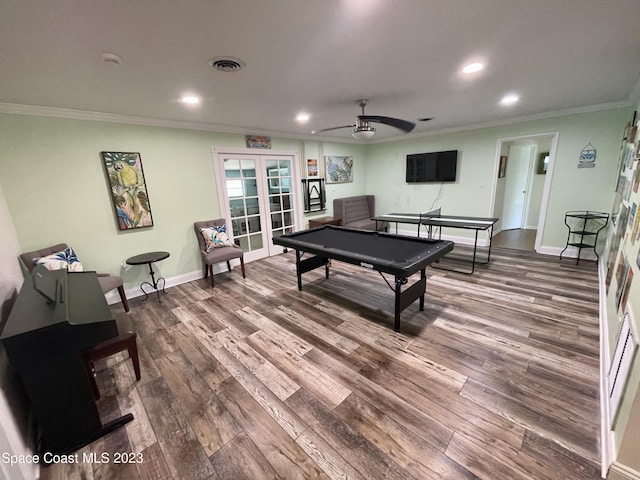 rec room featuring french doors, ornamental molding, ceiling fan, and dark wood-type flooring