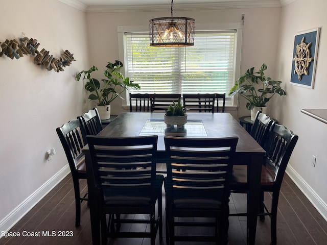 dining space with an inviting chandelier, dark hardwood / wood-style flooring, and ornamental molding