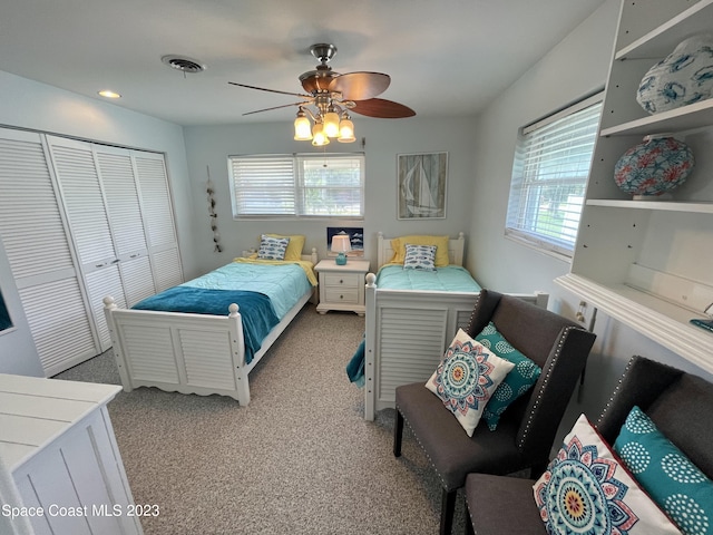 carpeted bedroom with a closet and ceiling fan