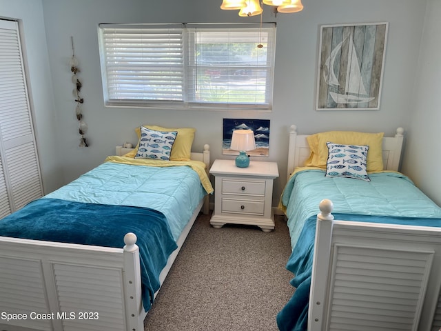 bedroom with a closet and dark colored carpet