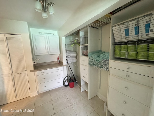 walk in closet featuring light tile floors