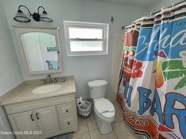 bathroom featuring toilet, large vanity, and tile flooring