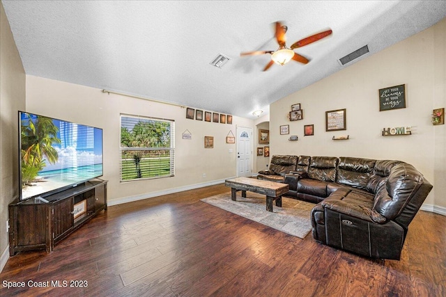 living room with lofted ceiling, ceiling fan, a textured ceiling, and dark hardwood / wood-style flooring