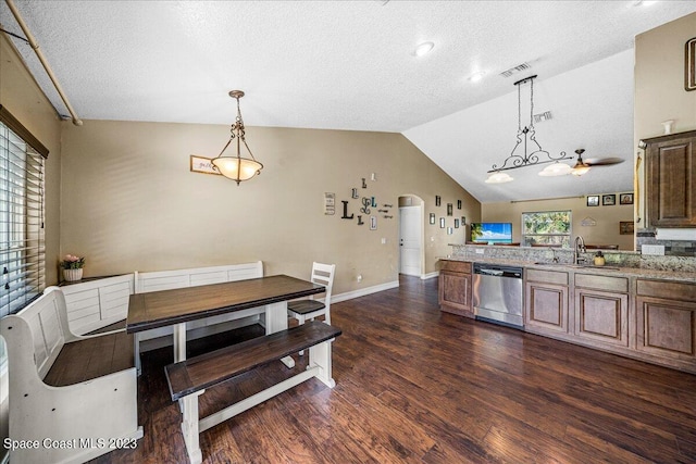 dining area with lofted ceiling, ceiling fan, sink, a textured ceiling, and dark hardwood / wood-style flooring