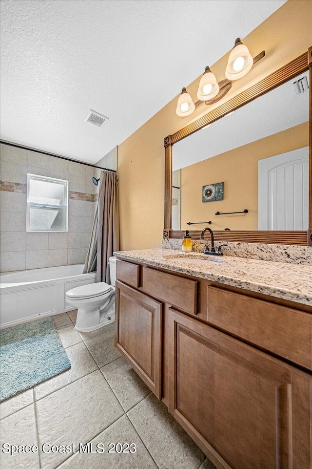 full bathroom with vanity, tile floors, a textured ceiling, toilet, and shower / bath combination with curtain