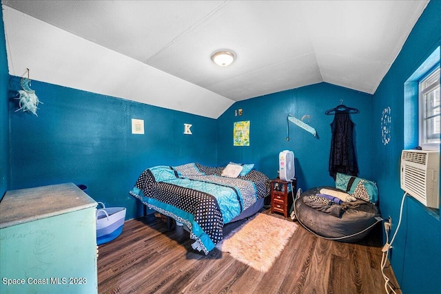 bedroom featuring dark hardwood / wood-style flooring and lofted ceiling