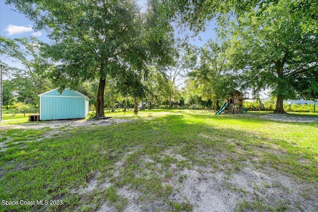 view of yard with a playground and an outdoor structure