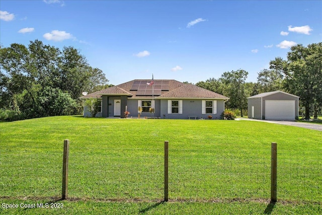 ranch-style house featuring a front yard, a garage, and solar panels