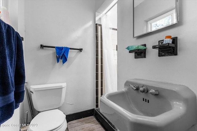 3706 Sutton Dr, Orlando, FL 32810 - bathroom with toilet and shower / tub combo with curtain