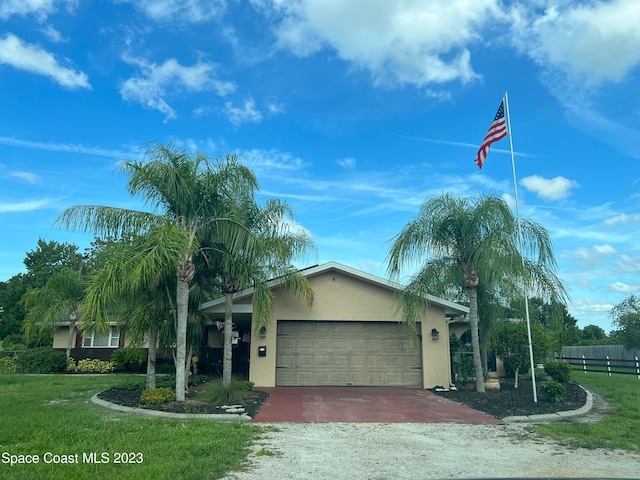 view of front of home featuring a front yard and a garage