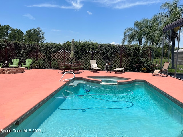 view of pool featuring an in ground hot tub and a patio