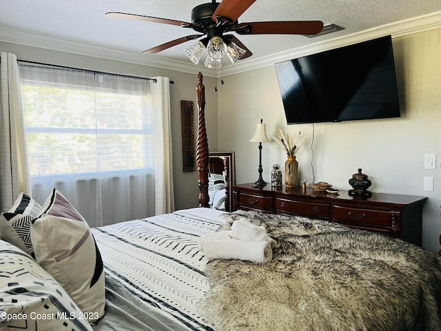 bedroom featuring a textured ceiling, ceiling fan, and ornamental molding