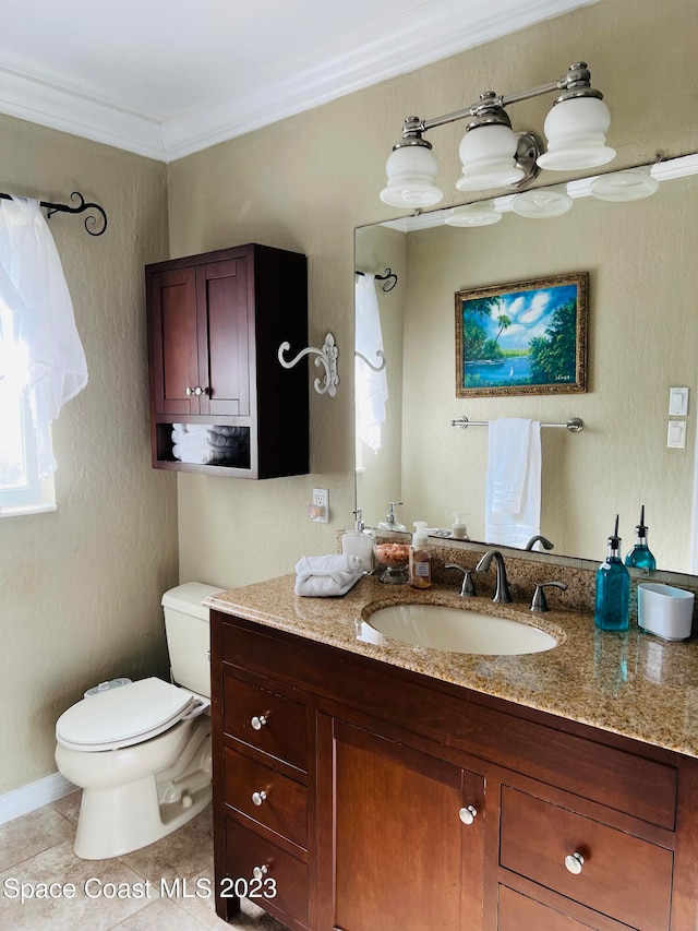 bathroom featuring toilet, ornamental molding, vanity, and tile flooring