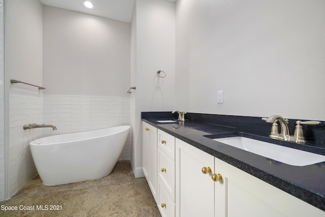 bathroom featuring double sink vanity and tile walls