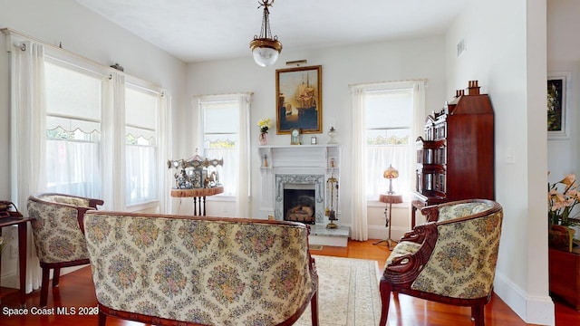 living room featuring plenty of natural light and light hardwood / wood-style flooring