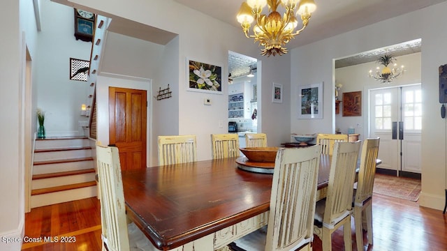 dining area with an inviting chandelier and dark hardwood / wood-style flooring