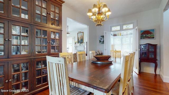 dining area featuring a chandelier and dark hardwood / wood-style flooring