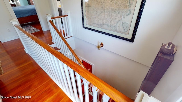 stairs with dark hardwood / wood-style flooring