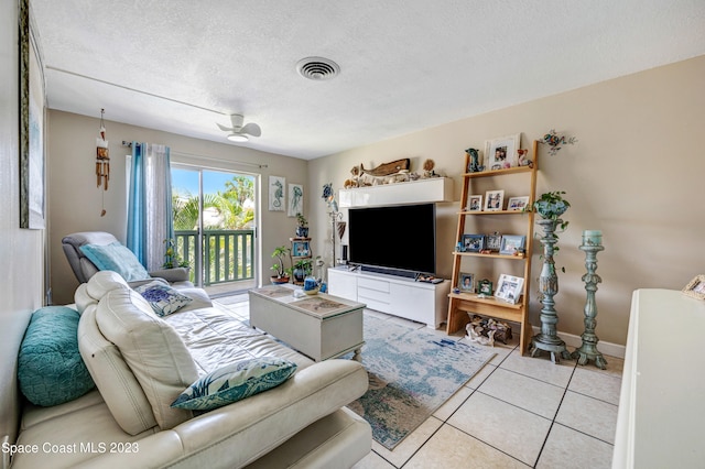 tiled living room featuring a textured ceiling