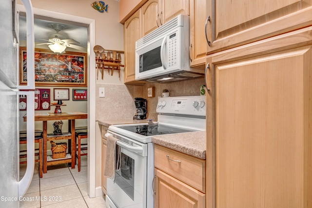 kitchen with white appliances, ceiling fan, backsplash, light tile flooring, and light brown cabinets