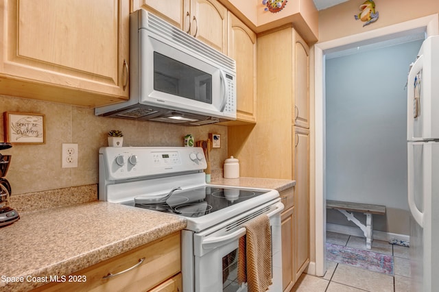 kitchen with backsplash, light brown cabinetry, white appliances, and light tile floors