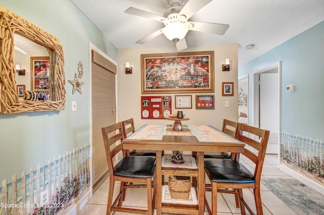 dining space with ceiling fan and light tile floors