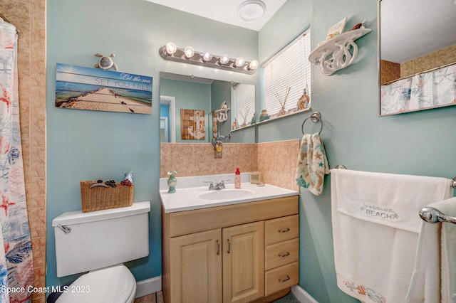 bathroom with toilet and vanity