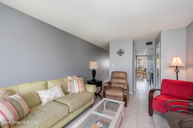 living room featuring light tile floors and a textured ceiling