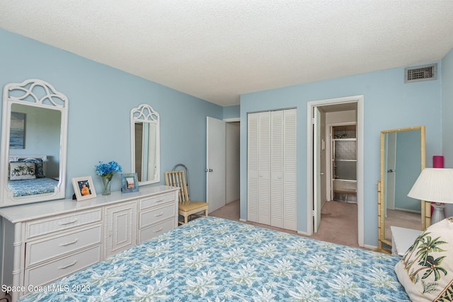 carpeted bedroom with a textured ceiling and a closet