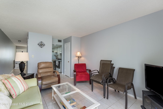 tiled living room featuring a textured ceiling