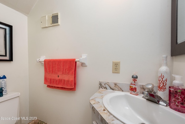 bathroom with vanity and toilet