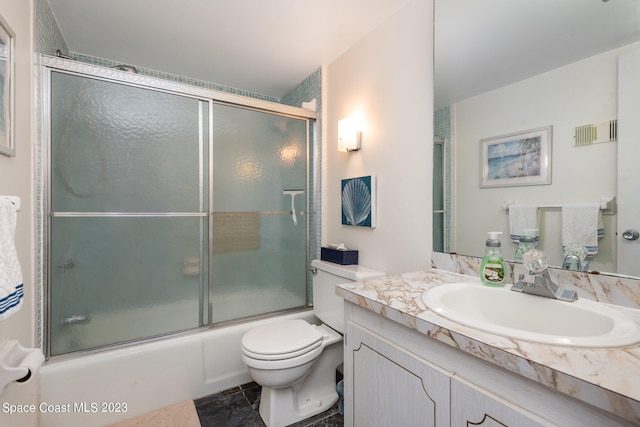 full bathroom with vanity, tile flooring, shower / bath combination with glass door, and toilet