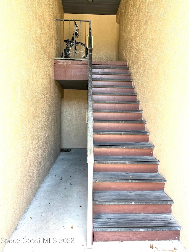 stairway with concrete flooring