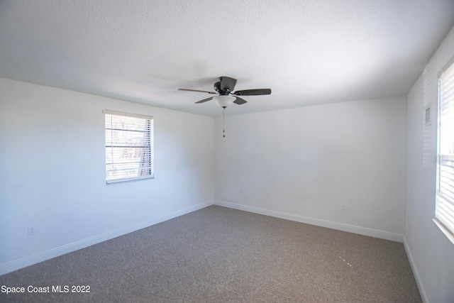 unfurnished room with carpet flooring and ceiling fan