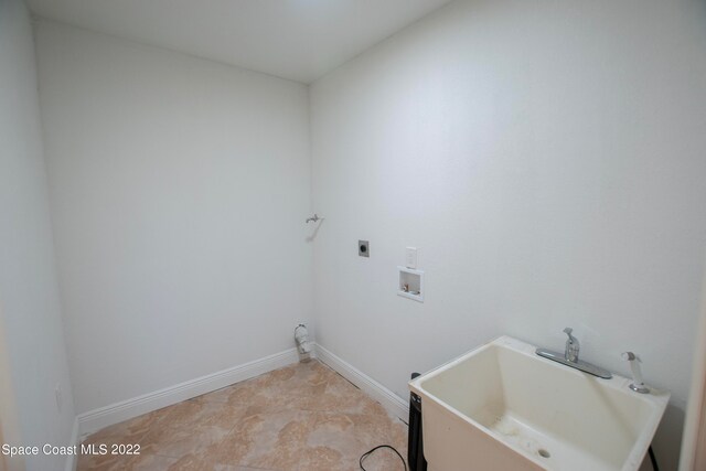 laundry area with washer hookup, electric dryer hookup, sink, and light tile flooring