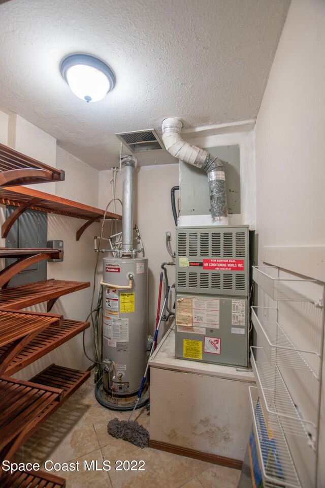 utility room with gas water heater