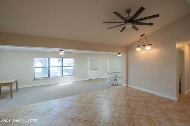 carpeted empty room featuring lofted ceiling and ceiling fan