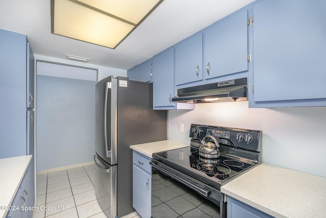 kitchen featuring black range with electric cooktop, stainless steel refrigerator, blue cabinetry, and light tile patterned floors