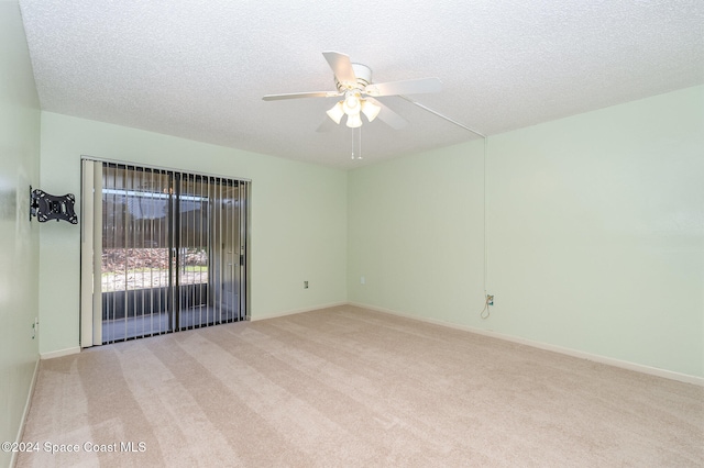 carpeted empty room featuring a textured ceiling and ceiling fan