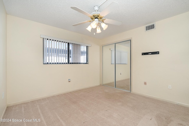 5800 N Banana River Blvd Unit 115, Cape Canaveral, FL 32920 - unfurnished bedroom with a closet, carpet floors, a textured ceiling, and ceiling fan