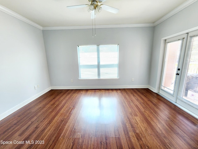 spare room with ceiling fan, crown molding, and dark wood-type flooring