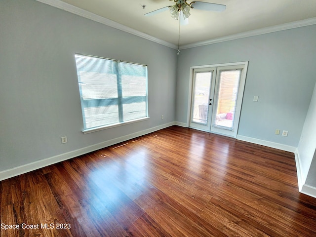 empty room with ornamental molding, ceiling fan, french doors, and dark hardwood / wood-style flooring