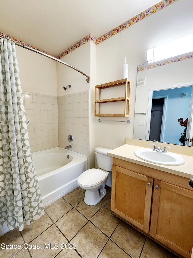 full bathroom with toilet, vanity with extensive cabinet space, tile flooring, and shower / tub combo