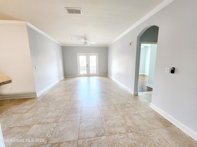 tiled spare room with ceiling fan, crown molding, and french doors