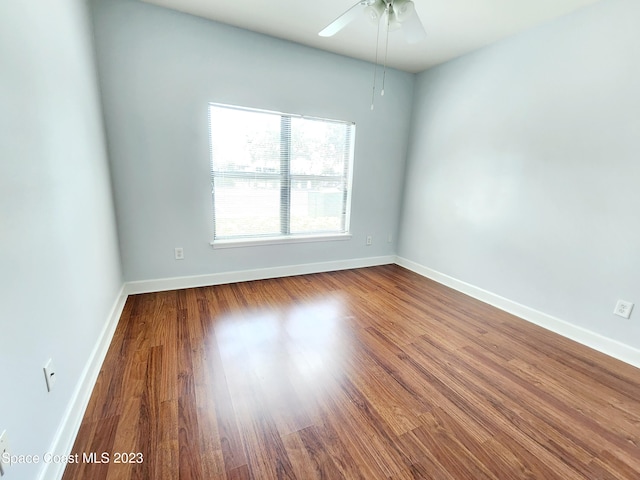 spare room featuring ceiling fan and dark wood-type flooring