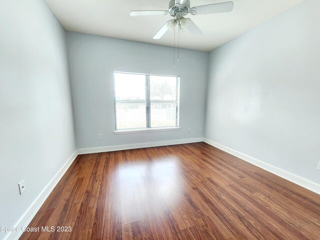 empty room featuring ceiling fan and dark hardwood / wood-style flooring