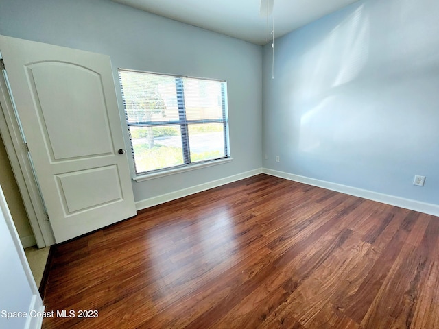 spare room with dark hardwood / wood-style floors