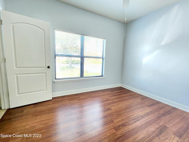 spare room featuring dark hardwood / wood-style flooring