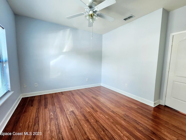 unfurnished room with ceiling fan and dark hardwood / wood-style flooring