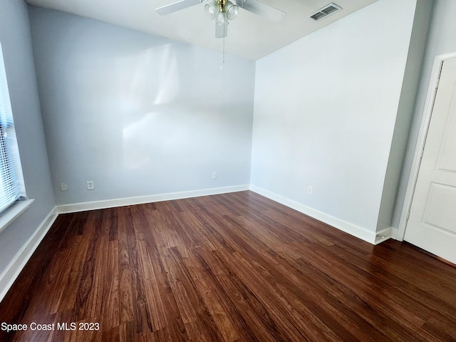 unfurnished room with ceiling fan and dark hardwood / wood-style flooring